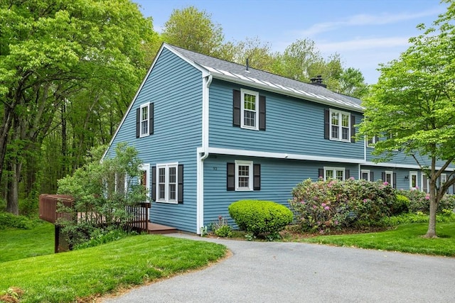 93 Cortland Ln Unit 0, Boxborough, MA 01719 - view of front facade featuring a chimney, a front yard, and a wooden deck