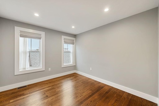 spare room with hardwood / wood-style floors