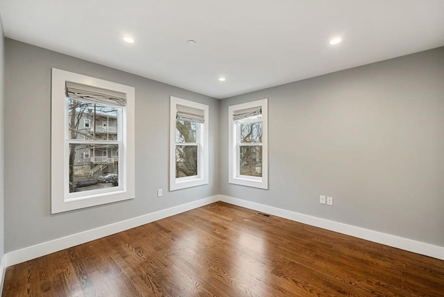 spare room featuring hardwood / wood-style flooring