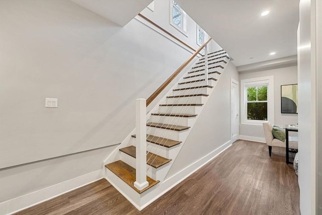 stairs with hardwood / wood-style flooring