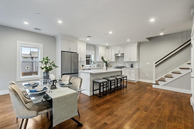 dining area with dark hardwood / wood-style flooring