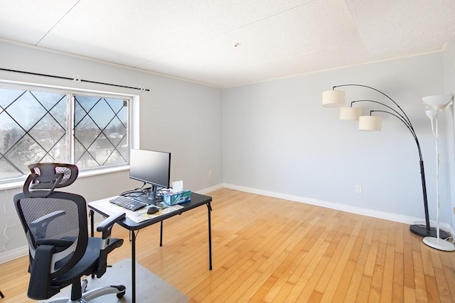 office featuring light wood-type flooring and baseboards