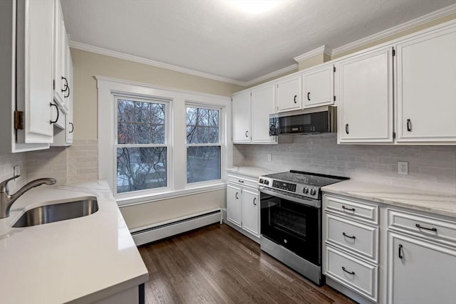 kitchen with white cabinets, sink, baseboard heating, and appliances with stainless steel finishes