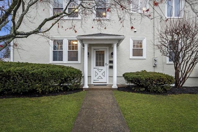 doorway to property featuring a yard