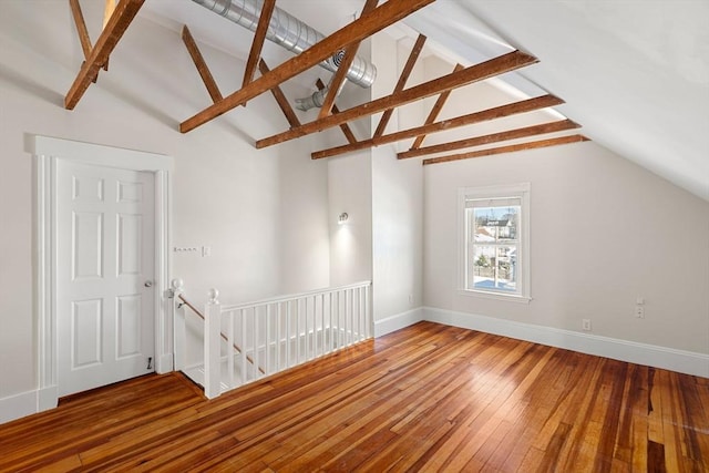 bonus room with hardwood / wood-style floors and lofted ceiling with beams