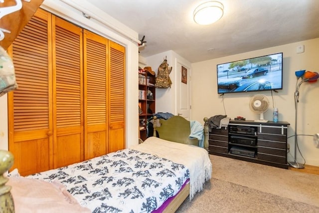 bedroom with carpet and a closet