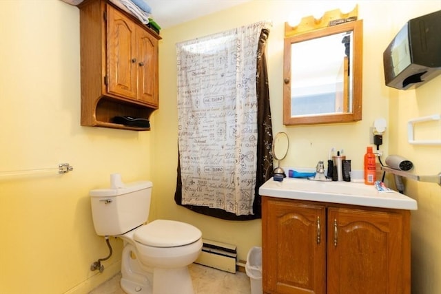 bathroom featuring a baseboard heating unit, vanity, toilet, and baseboards