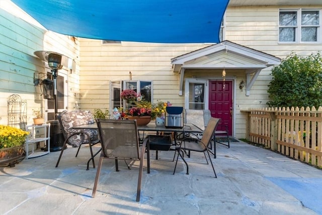 view of patio with outdoor dining space and fence