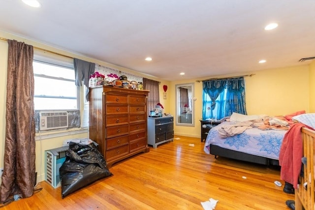 bedroom featuring cooling unit, visible vents, light wood finished floors, and recessed lighting