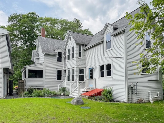624 Western Ave, Gloucester, MA 01930 - rear view of property featuring roof with shingles, a lawn, and a chimney