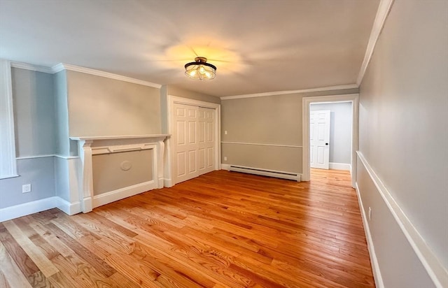 624 Western Ave, Gloucester, MA 01930 - spare room with a baseboard radiator, ornamental molding, and light wood finished floors