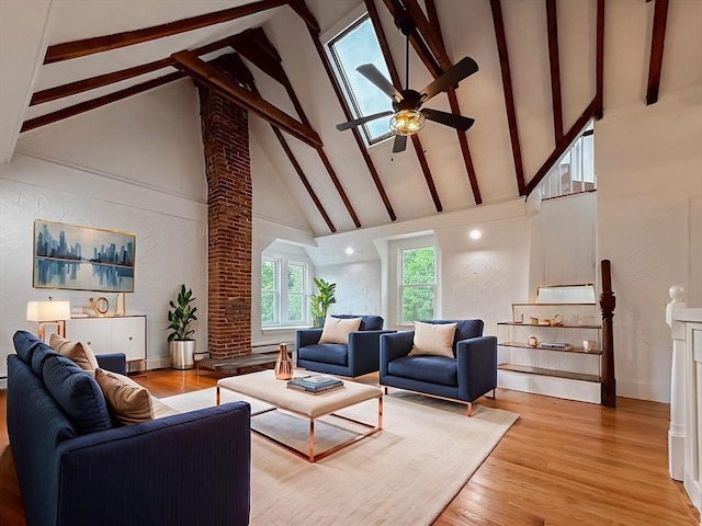 624 Western Ave, Gloucester, MA 01930 - living room featuring high vaulted ceiling, ceiling fan, beamed ceiling, light wood-style floors, and decorative columns