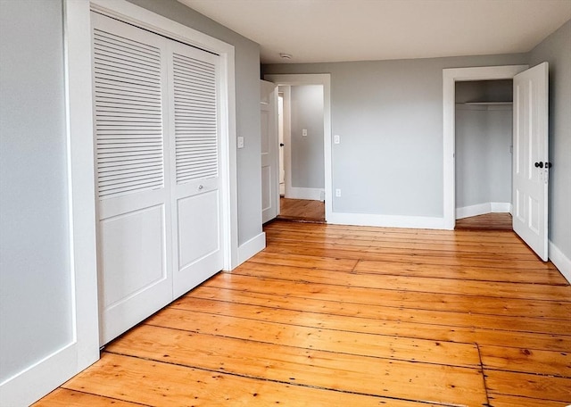624 Western Ave, Gloucester, MA 01930 - unfurnished bedroom with light wood-style floors and a closet