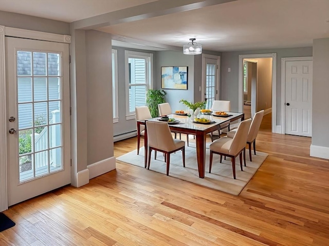 624 Western Ave, Gloucester, MA 01930 - dining room with a baseboard radiator, light wood-type flooring, and a chandelier