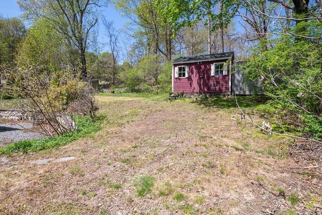 view of yard with an outdoor structure and a storage unit
