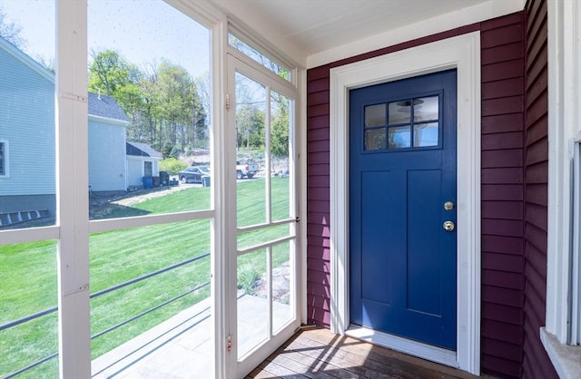 entrance to property with a lawn