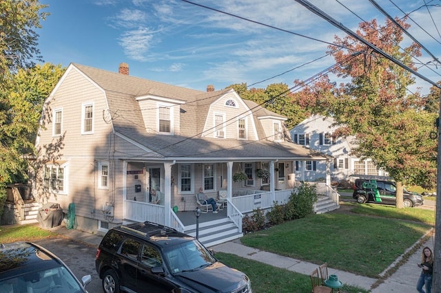 view of front of property featuring a porch and a front lawn