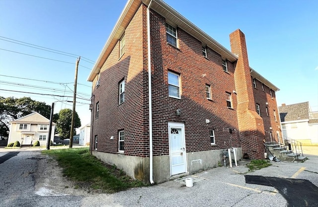 475-479 Sea St Unit 2, Quincy, MA 02169 - view of property exterior with brick siding and a chimney