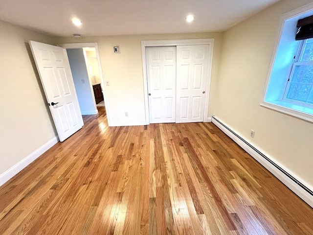 475-479 Sea St Unit 2, Quincy, MA 02169 - unfurnished bedroom with a baseboard radiator, light wood finished floors, recessed lighting, and a closet
