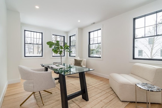 office space with light wood-style floors, baseboards, and recessed lighting