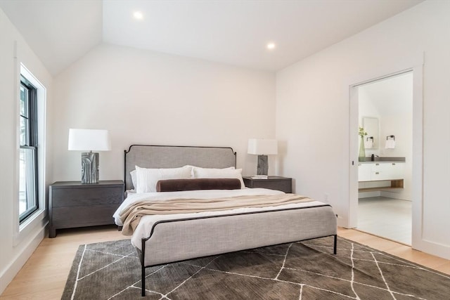 bedroom featuring vaulted ceiling, ensuite bath, wood finished floors, and recessed lighting