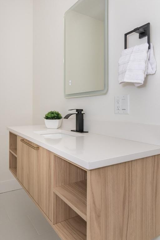 bathroom with tile patterned flooring and vanity