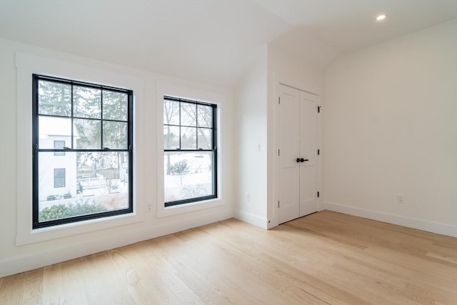 interior space featuring baseboards, light wood-style floors, recessed lighting, and a healthy amount of sunlight