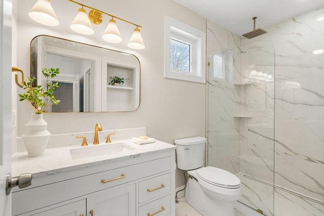 bathroom featuring vanity, toilet, and tiled shower