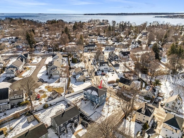 snowy aerial view with a water view