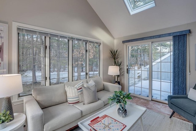 living area featuring high vaulted ceiling and a skylight