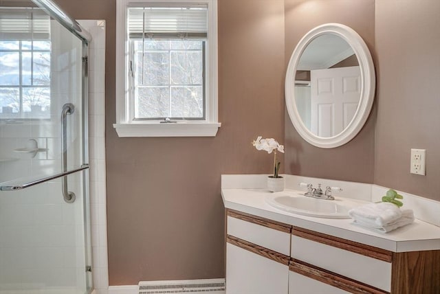 full bathroom with baseboard heating, a stall shower, plenty of natural light, and vanity