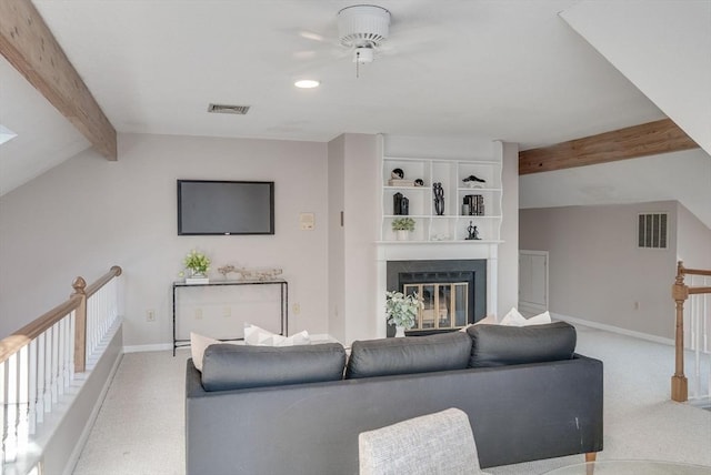 living room with a glass covered fireplace, light carpet, visible vents, and baseboards