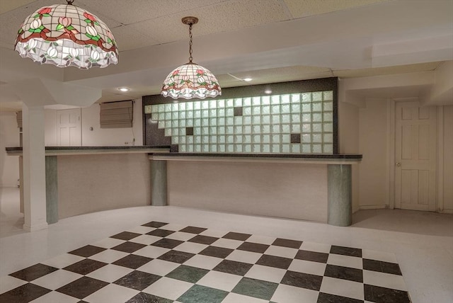 kitchen with dark countertops, decorative light fixtures, and tile patterned floors