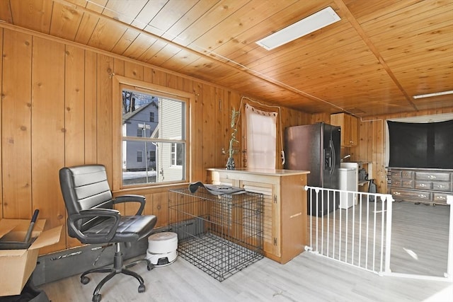 office space featuring wood finished floors, wood ceiling, and wooden walls