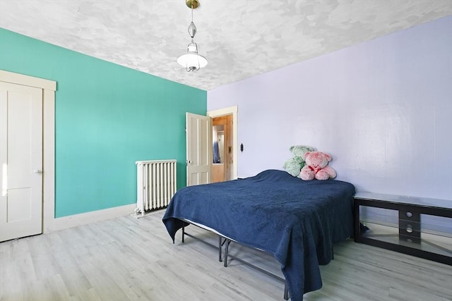 bedroom featuring baseboards and wood finished floors