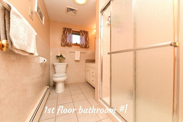 173 Standish Rd, Bourne, MA 02562 - bathroom with a shower stall, tile patterned flooring, tile walls, baseboard heating, and toilet