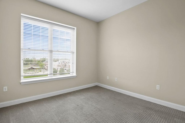 empty room with carpet flooring and baseboards