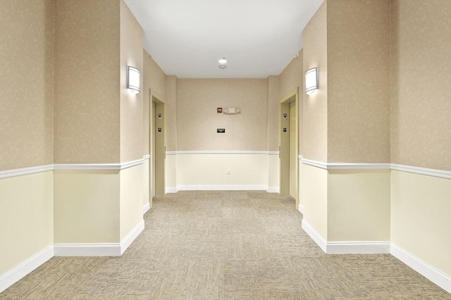 hall with carpet and baseboards