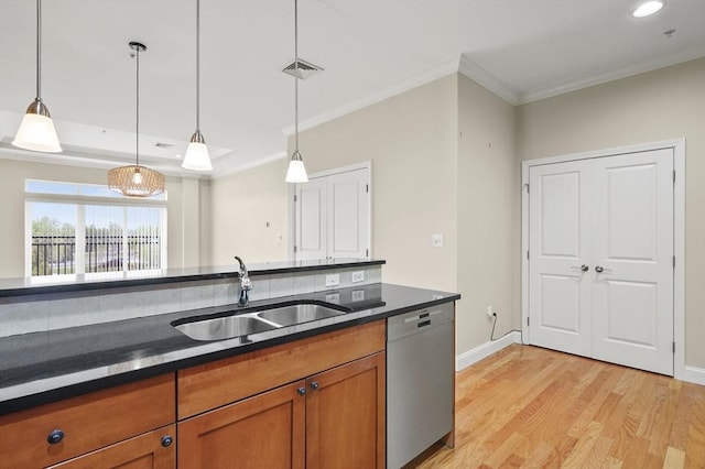 kitchen featuring dishwasher, brown cabinets, a sink, dark countertops, and ornamental molding