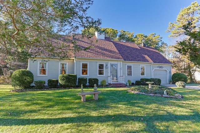 view of front of home featuring a garage and a front lawn