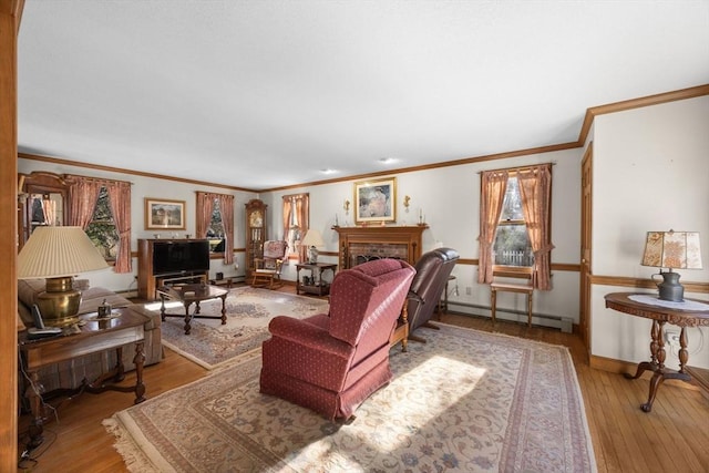 living room with light hardwood / wood-style floors, crown molding, baseboard heating, and a brick fireplace