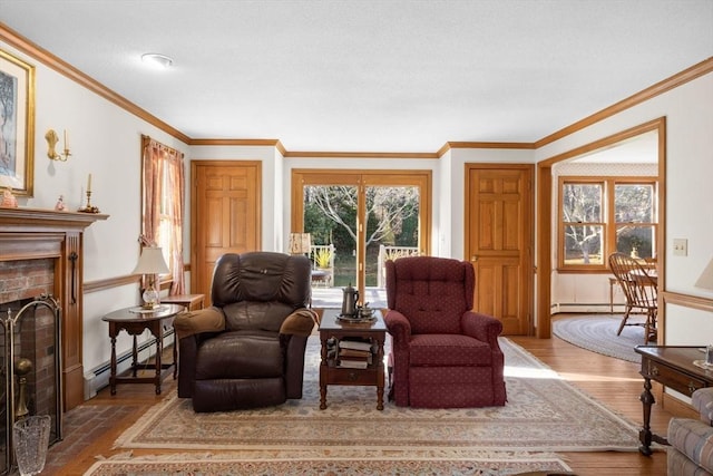 living area featuring a brick fireplace, light wood-type flooring, crown molding, and a baseboard radiator