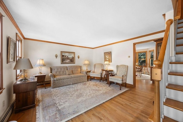 living room featuring hardwood / wood-style floors, baseboard heating, and crown molding