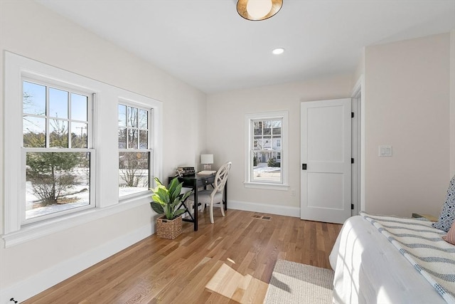 bedroom featuring light hardwood / wood-style floors and multiple windows