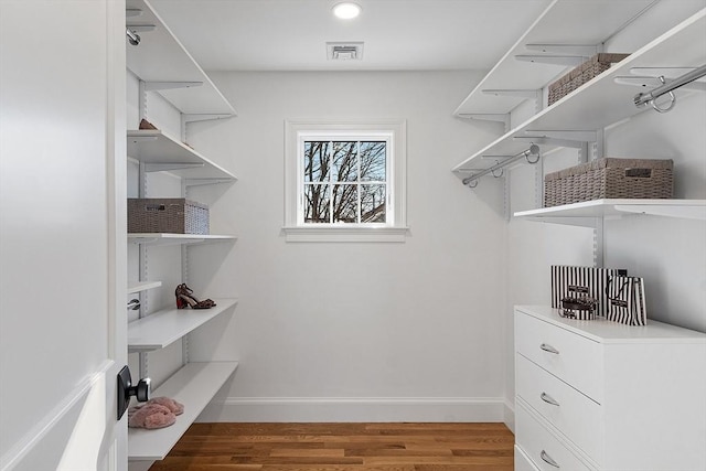 walk in closet with hardwood / wood-style floors