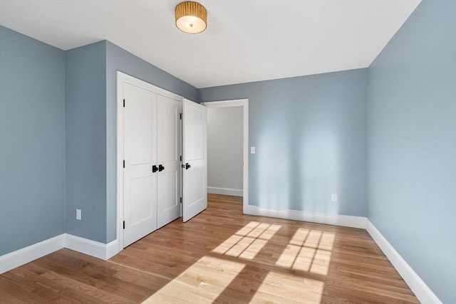 unfurnished bedroom featuring a closet and light hardwood / wood-style flooring