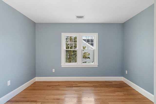 spare room with light hardwood / wood-style flooring