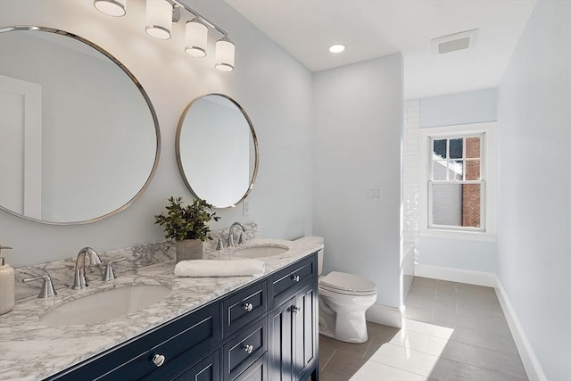 bathroom featuring toilet, a bathing tub, tile patterned flooring, and vanity