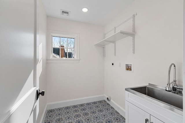 washroom featuring sink, electric dryer hookup, hookup for a washing machine, and cabinets