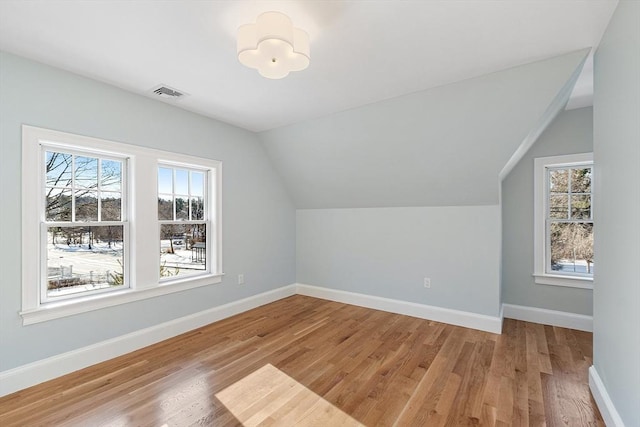 bonus room with lofted ceiling and wood-type flooring